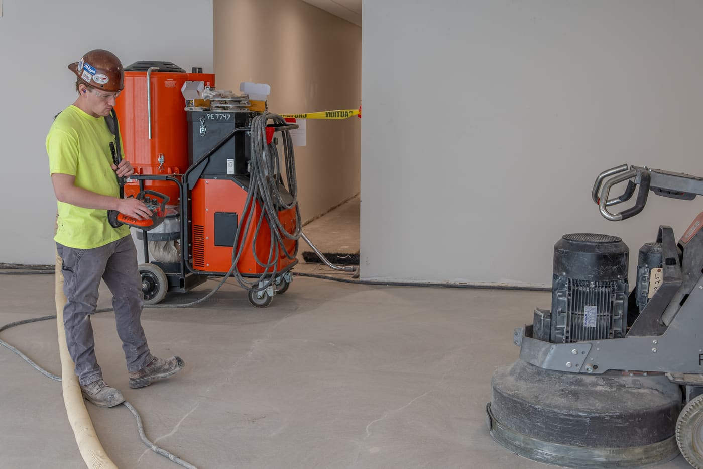 Operator running a planetary grinder with industrial dust extraction